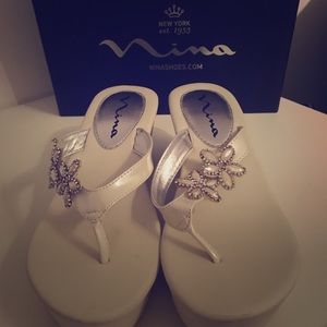 White platform sandals with embellishments